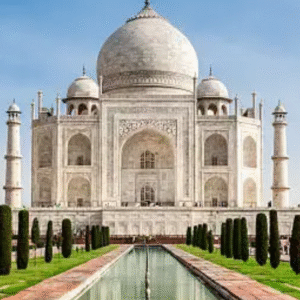 Front view of the iconic Taj Mahal with clear blue sky and reflecting pool in Agra, India.