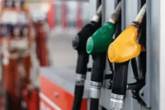 Fuel nozzles at a petrol station, including diesel, petrol, and alternative fuel options.