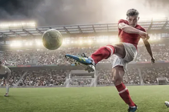 A member of a team is playing football on the field football with other team in rain .