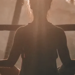 Woman meditating at sunrise with serene forest background