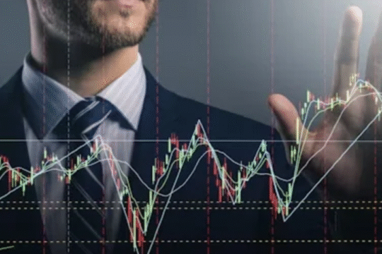 A young man standing confidently in an urban setting wearing stylish streetwear, with modern buildings and a clear sky in the background.
