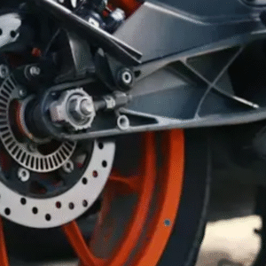 Close-up view of a motorcycle's rear wheel with orange alloy rims and disc brake system