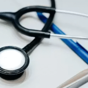 Stethoscope and pen placed on a notebook symbolizing medical practice and healthcare documentation.