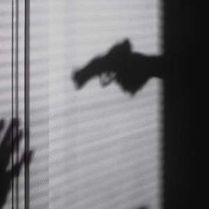 A woman standing alone near a forested road in foggy weather, conveying a mood of isolation and mystery.
