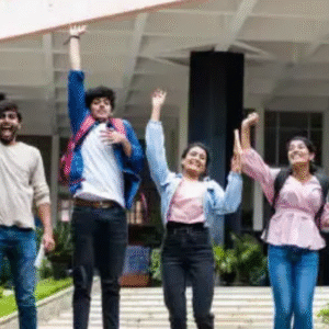 Group of happy Indian college students jumping and celebrating success on campus.