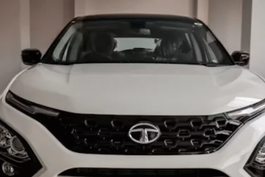 Stock market display with Tata Motors share graph falling, symbolizing a decline in stock price.