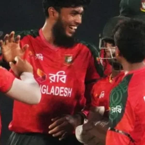 Bangladeshi cricket players in red and green uniforms celebrate a moment in a match.