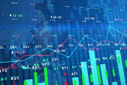 A digital screen displays a world map overlaid with financial charts, graphs, and numbers.