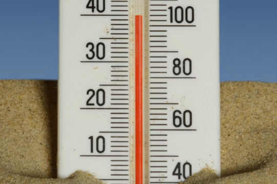 A child sleeps on a woven mat, with a patterned cloth partially covering them.