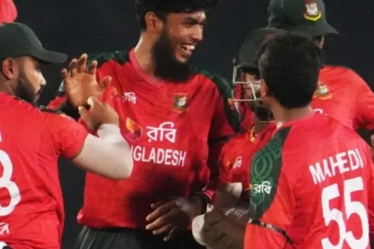 Bangladeshi cricket players in red and green uniforms celebrate a moment in a match.
