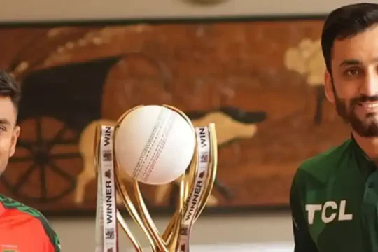 Two cricketers, one in Bangladesh and one in Pakistan jersey, with a trophy.