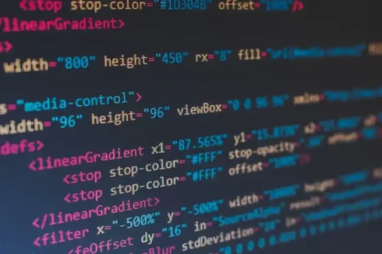 Close-up of computer screen displaying lines of colorful HTML/SVG code.