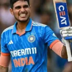 Indian cricketer Shubman Gill celebrating with his bat after scoring.