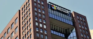 A modern brick building with glass sections and the Microsoft logo.