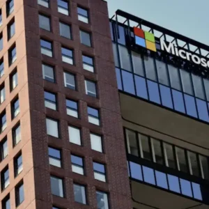 A modern brick building with glass sections and the Microsoft logo.