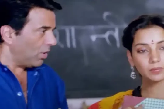 Bollywood actors Dharmendra and Meenakshi Seshadri in a scene from a film.