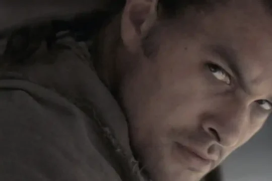 A close-up of Jason Momoa as Duncan Idaho, looking intensely at the camera.