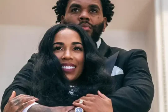 Rapper Kevin Gates embraces his wife Dreka in a formal setting.