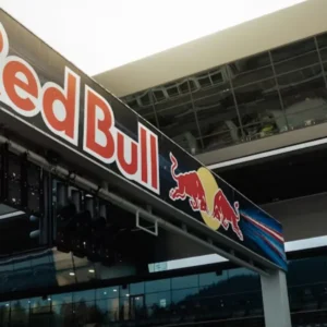 A large Red Bull banner with its logo prominently displayed at a race track.