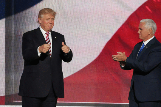 Donald Trump gives thumbs up; Mike Pence claps.