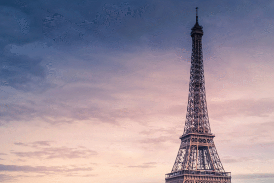The Eiffel Tower stands tall over the Seine River.