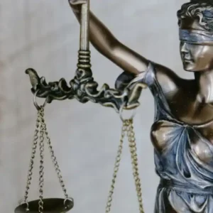 A bronze statue of Lady Justice, blindfolded and holding scales and a sword.