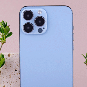 A light blue iPhone with multiple cameras, next to green leaves.