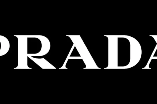 The word "PRADA" in white serif font on a black background.