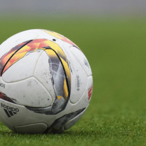 White soccer ball with colorful designs on green grass