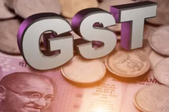 GST letters placed over Indian currency notes and coins symbolizing financial regulation and taxation in India.