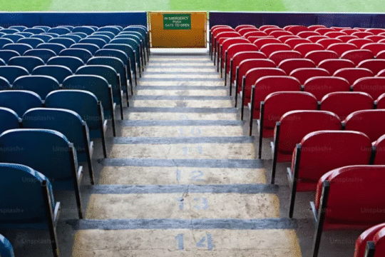 "Close-up of a red cricket ball with stitched seam on a dark background, symbolizing intense match action in MLC 2025."