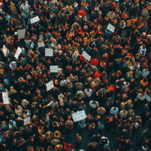 Aerial view of a massive crowd of protesters holding placards during a nationwide strike or public demonstration.