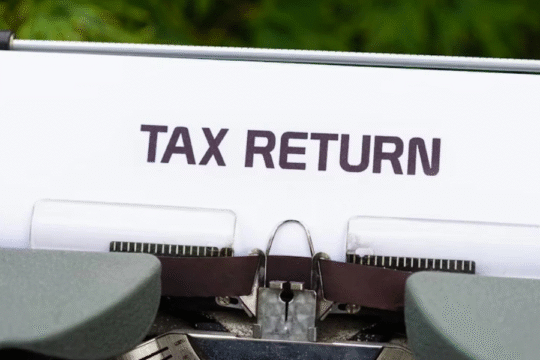 Tax Return document in typewriter with greenery background