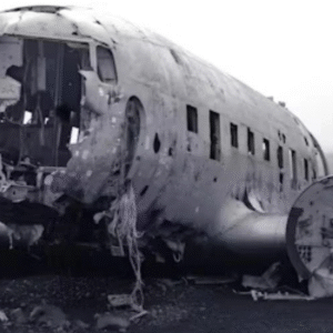 Abandoned and damaged aircraft fuselage wreck on desolate landscape