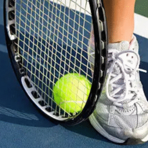Tennis racket and ball near player’s feet