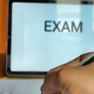 Students sitting in a classroom appearing for a written exam with focus and concentration.