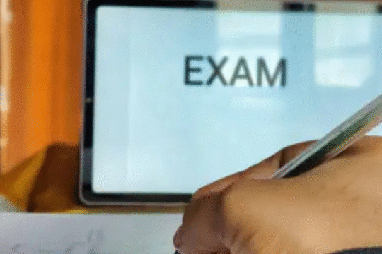 Students sitting in a classroom appearing for a written exam with focus and concentration.