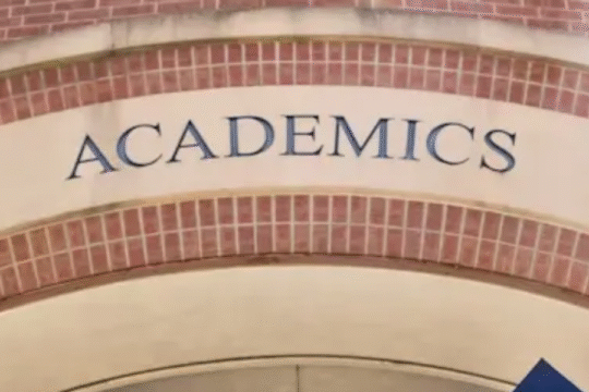 Entrance to an academic building with "ACADEMICS" inscribed on an arch