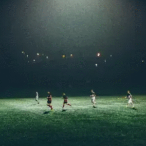 Football match under bright floodlights on a rainy night