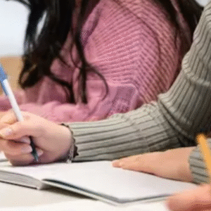 Students writing in notebooks during a classroom session