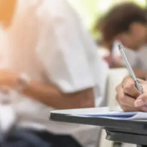 Students writing exams in a classroom with focused atmosphere