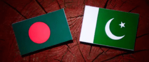 Flags of Bangladesh and Pakistan placed side by side on a wooden background, symbolizing a cricket rivalry or diplomatic relationship.