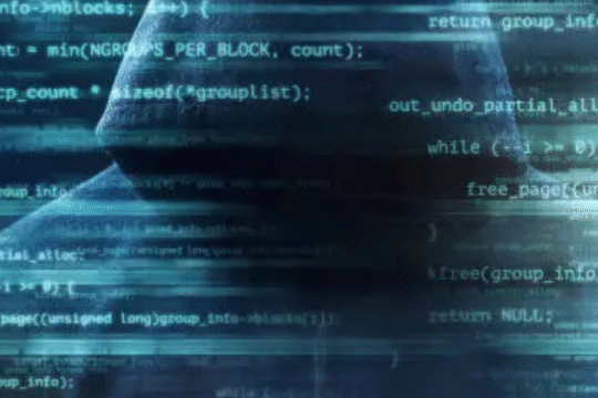 Silhouetted figure in hoodie overlaid with transparent computer code, symbolizing digital hacking and cyber intrusion.