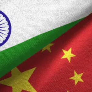 Close-up of Indian and Chinese flags overlapping, symbolizing bilateral relations.