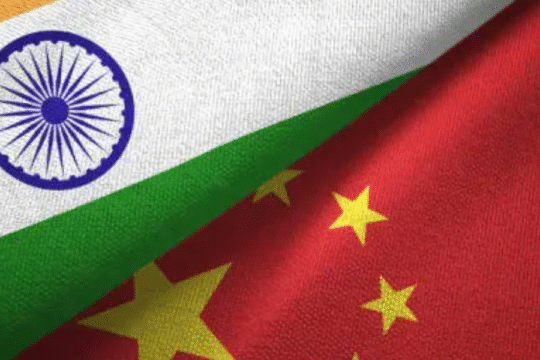 Close-up of Indian and Chinese flags overlapping, symbolizing bilateral relations.