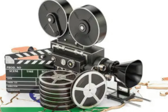 Old-fashioned film camera and clapperboard on India map, symbolizing Indian cinema.