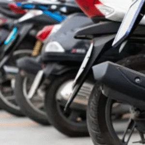 Row of parked motorcycles and scooters in an outdoor lot