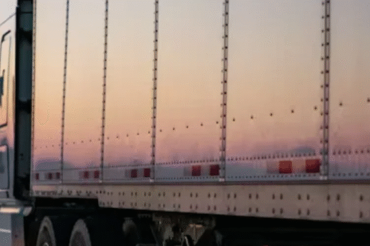 Close-up of a freight truck on highway at sunset