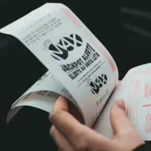 Close-up of person holding Lotto Max lottery tickets