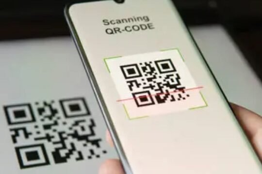A smartphone scanning a QR code for digital identification on a white surface
